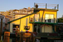 Yellow two level floating home at Victoria Fisherman's Wharf.jpg